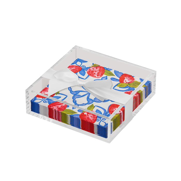 The Sophistiplate Everyday Cocktail Napkin with Napkin Tray features a clear acrylic holder displaying colorful napkins adorned with strawberries, blue flowers, green leaves, and finished with a white satin ribbon.