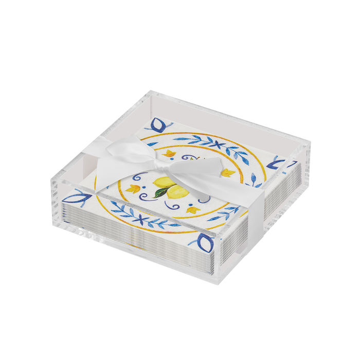 The Sophistiplate Everyday Cocktail Napkin with Napkin Tray features a clear acrylic holder with a stack of blue and yellow floral paper napkins, tied with a white ribbon.