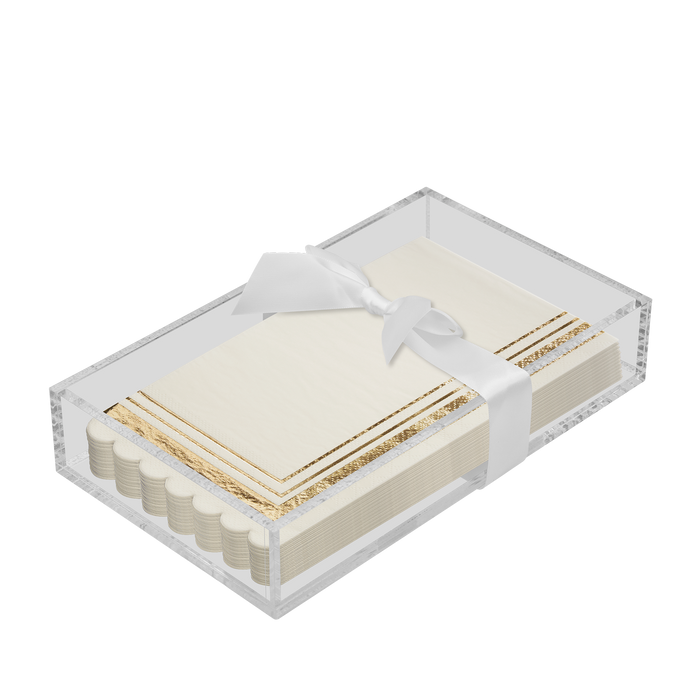 The Sophistiplate Everyday Guest Towel with Napkin Tray features neatly stacked cream napkins with gold trim, presented in a clear rectangular tray and tied with a white satin ribbon bow.