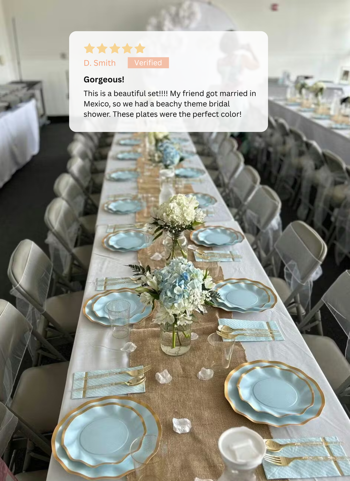 A banquet table is set for a bridal shower with Sophistiplate’s Everyday Sky Blue Table Setting, including disposable plates, gold-trimmed chargers, striped napkins, and floral centerpieces. A five-star review appears at the top.