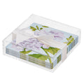 The Sophistiplate Floral Cocktail Napkin with Napkin Tray features floral-patterned napkins with purple hydrangeas and green leaves in a clear tray—ideal for modern tabletops.
