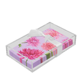 A Sophistiplate Floral Guest Towel set, featuring dahlia design napkins, is elegantly arranged in a ceramic and acrylic napkin tray.