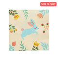 The Sophistiplate Folklore Easter Cocktail Napkins (20pk) feature a blue bunny with pink ears and tail, surrounded by colorful flowers and green leaves—perfect for Easter parties. A red SOLD OUT label is shown in the top right corner.