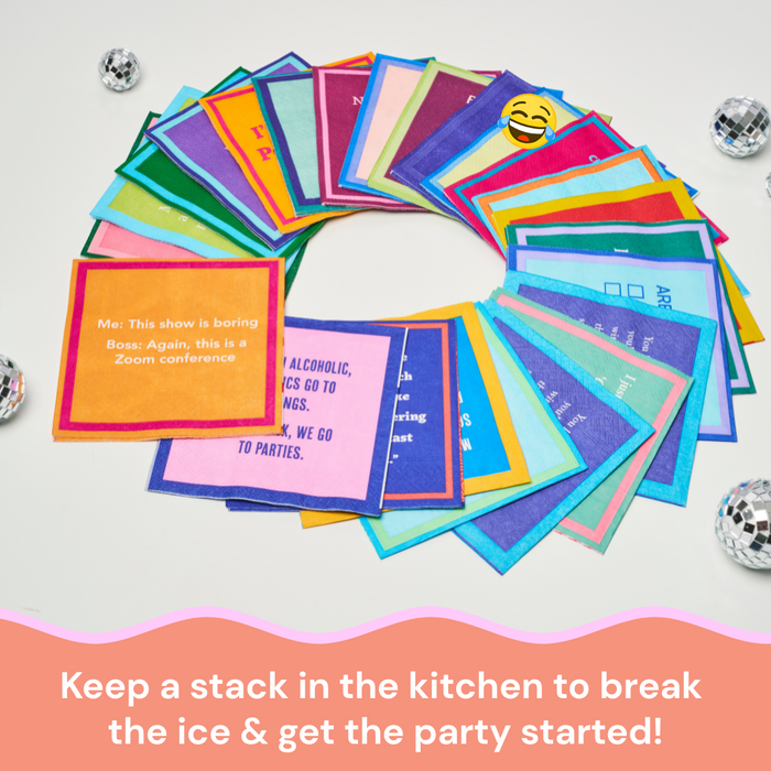 A stack of Drinks On Me’s Growing up in 80's Napkins sits on a white surface with party cards, disco balls, and funny cocktail napkins nearby—perfect for breaking the ice and getting the party started!.