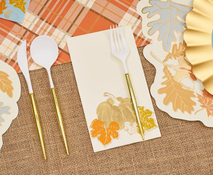 The Gilded Harvest Table Setting by Sophistiplate includes designer disposable plates and white plastic cutlery with gold handles on a pumpkin-leaf napkin, all arranged on burlap for a festive, ready-to-host fall celebration.