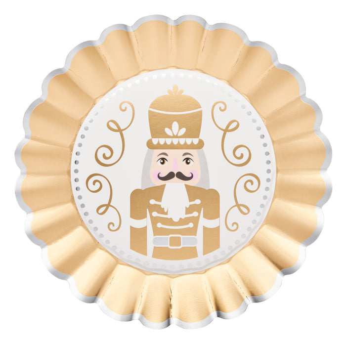The Sophistiplate Gilded Nutcracker Dinner Plates (8pk) showcase a round, gold and white scalloped-edge design with an illustrated nutcracker soldier—complete with mustache, tall hat, and decorative swirls—making them the perfect festive tableware to elevate your holiday celebrations with elegant style.