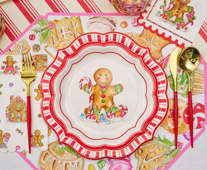 Create a festive tablescape with the Gingerbread Table Setting by Sophistiplate, featuring plates with a gingerbread man and candy cane, plus holiday-themed napkins, placemat, and gold cutlery—all with colorful Christmas motifs.