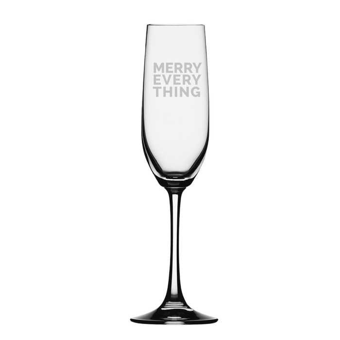 The Maple Glass Champagne Flute | Merry Everything | 8oz features “MERRY EVERY THING” etched in white capitals on the bowl, displayed upright against a plain white background.