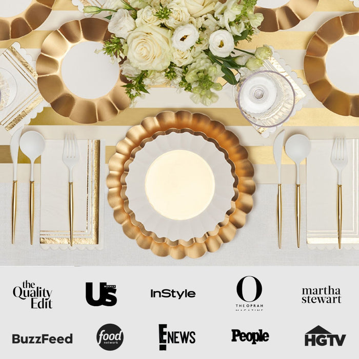 The Gold & White Table Setting by Sophistiplate LLC features scalloped designer disposable plates, gold cutlery, white napkins, and a floral centerpiece, with media logos like BuzzFeed, Food Network, and HGTV along the bottom.