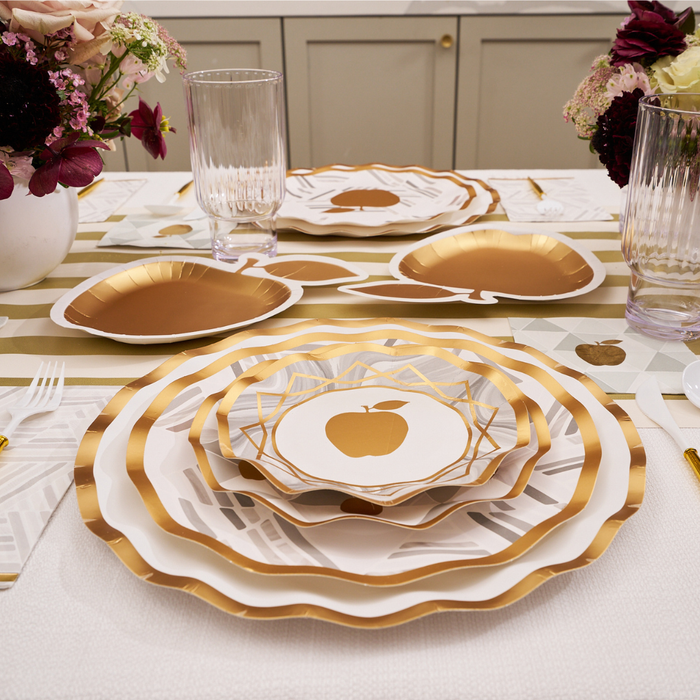 Create an elegant table setting with Sophistiplate’s Golden Apple Die-Cut Salad Plates (8pk), featuring a striking gold apple design on white plates. These disposable salad plates add both convenience and festive flair—perfect for Rosh Hashanah celebrations. Pair them with clear ribbed glasses, gold utensils, and white vases filled with flowers for a sophisticated touch.