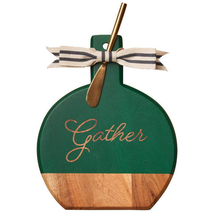 The Maple Green Acacia Bevel Board w/ Spreader features "Gather" engraving, a striped bow, and a gold cheese spreader—perfect as a 9.75 x 8" serving or cheese board for any occasion.