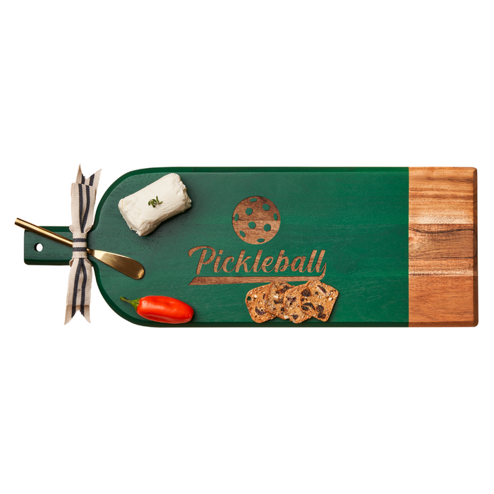 The Maple Acacia Bevel Board Long Green w/ Ribbon & Gold Spreader Knife | Pickleball (20 x 7") features a gold knife, cheese log, red pepper, crackers, and a ribbon-tied handle in a charming green and wood design.