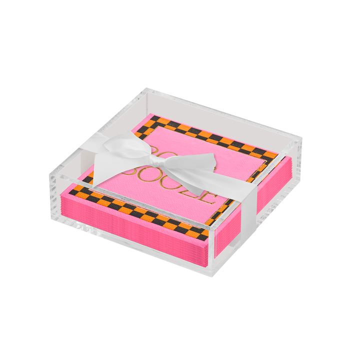 The Sophistiplate Halloween Cocktail Napkin with Napkin Tray features pink napkins with a black and orange checkered border, elegant gold writing, and comes in a clear acrylic tray tied with a white ribbon—perfect for modern tabletop decor.