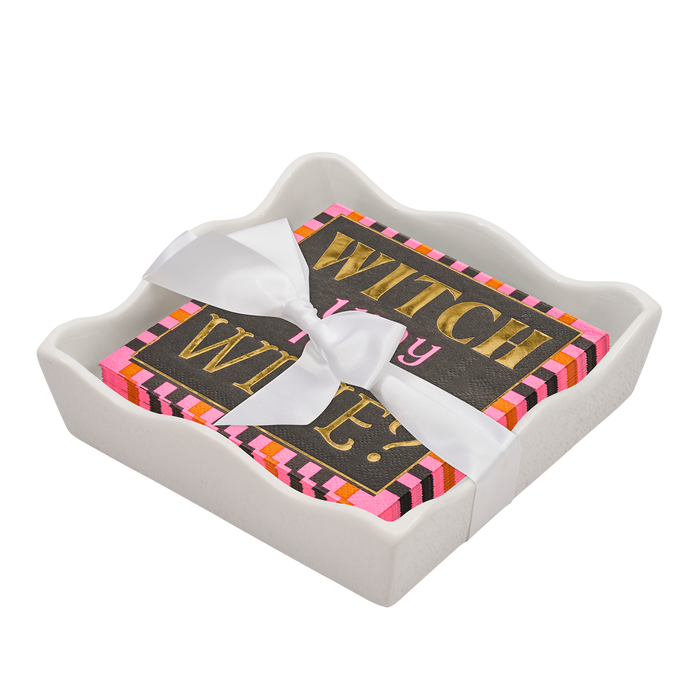 The Sophistiplate Halloween Cocktail Napkin with Napkin Tray includes a modern white ceramic holder and colorful napkins that read "WITCH way to the WINE?" in gold, pink, and white, tied with a chic white ribbon—perfect for festive tabletop decor.