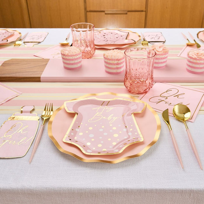 The Hey Baby Blush Table Setting by Sophistiplate LLC includes designer onesie-shaped plates, striped Oh Baby napkins, pink cups, gold cutlery, and cupcake wrappers—perfect for a pastel pink and gold baby shower.