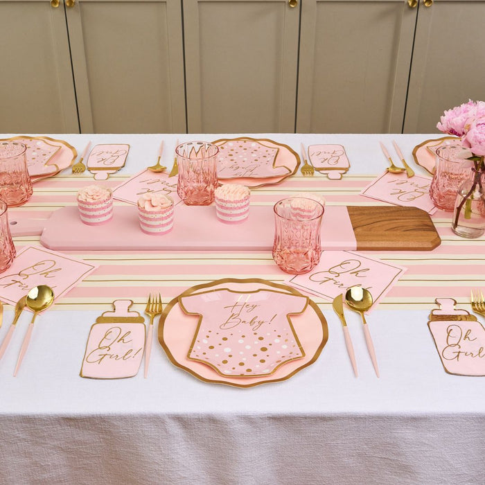 The Hey Baby Blush Table Setting by Sophistiplate LLC features pink and gold decor, “Oh Girl!” napkins, designer disposable plates, pink cupcakes and glasses, gold cutlery, and a lovely pink flower centerpiece.