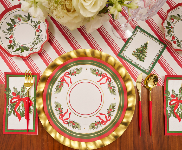 Set a festive table with gold and red utensils, holiday-themed napkins, and a centerpiece of white flowers atop a red and white striped tablecloth. Featuring the charming “Home for the Holidays” holly and ribbon design by Sophistiplate, these dinner plates (8-pack) add both convenience and cheer to your Christmas celebration.
