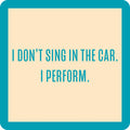 The I Perform Coaster by Drinks On Me features bold green text on a beige square with a green border—reading "I DONT SING IN THE CAR. I PERFORM."—a funny drink coaster perfect for unique housewarming gifts or bar cart accessories.