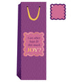 The Joy Bag- Wine Bag by Drinks On Me is a tall, purple reusable bag with wavy lines, yellow handles, and a pink label asking "Can other bags fit this much JOY?"—plus a scalloped-edge gift tag—perfect for any celebration.