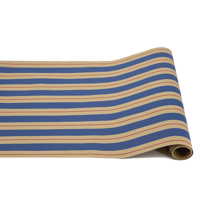 The Hester & Cook Kraft Navy & Red Awning Stripe Runner (20x25") features horizontal blue, beige, and thin red stripes on tan kraft paper—perfect for use as a table runner and shown unrolled on a white surface.