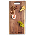 The Maple Live Edge Walnut Single Handle Charcuterie Board | Parisian Charcuterie (24" x 12") features end-grain walnut, a handle, and an engraved "CHARCUTERIE," styled with crackers, cheese, brie with peppers, and green grapes.