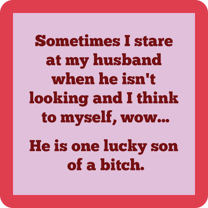 The Drinks On Me "Lucky Son of a Bitch Coaster" features a funny quote on pink with a red border—perfect for bar cart accessories or as a unique hostess gift.