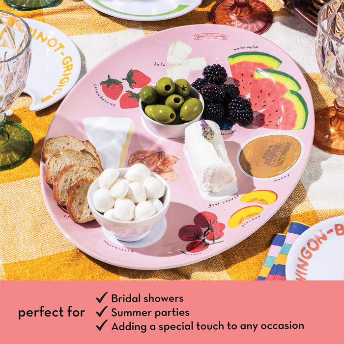 The Maple Meg Quinn Melamine Serving Tray, featuring bread, cheese, marshmallows, olives, blackberries, and watermelon slices on a yellow-checkered tablecloth. Ideal charcuterie tray for bridal showers, summer parties, and special occasions.