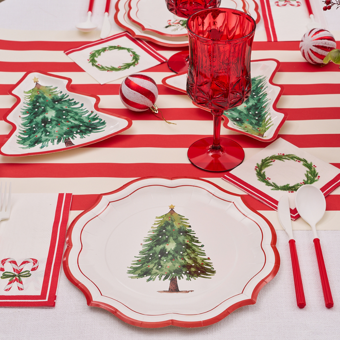 Create a festive Merry and Bright table setting with Sophistiplate Merry and Bright Paper Dinner Plates (8pk), a red and white striped runner, red glassware, holiday napkins, and Christmas ornaments for decoration.