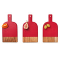 Three Maple Mini Bevel Boards—Set of 3 with Ribbon, Red, 8x4.25"—are arranged in a row displaying an orange slice, half a fig, and two green grapes on a white background.