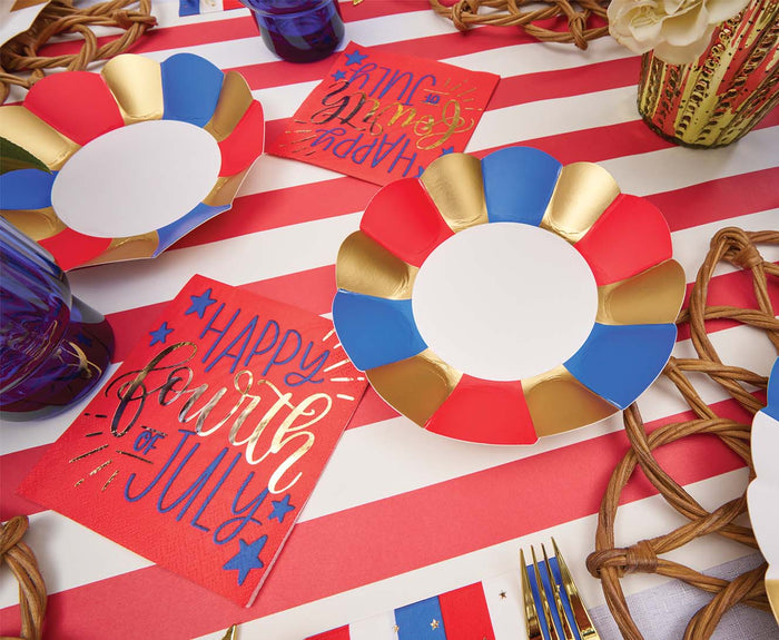 A festive table set with Sophistiplate's Modern Patriotic Appetizer/Dessert Bowls (8pk), colorful plates, gold accents, and "Happy Fourth of July" napkins—perfect for your Independence Day celebration.