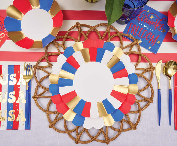 A festive table features Sophistiplate's Modern Patriotic Appetizer/Dessert Bowls (8pk), accented with red, white, blue, and gold hues, sparkling decor, woven placemats, and themed napkins—perfect for celebrating the USA in style.