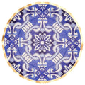 The Sophistiplate Moroccan Nights Wavy Paper Dinner Plate (8pk) features an intricate blue and white floral and geometric pattern with a thin gold border, reminiscent of elegant Moroccan tile designs.