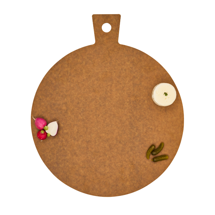 The Maple Natural Wood Composite Round Hostess Board, durable and dishwasher safe, features a handle and showcases radishes, mini pickles, and a creamy dip arranged artfully on a white background. Ideal for everyday use.