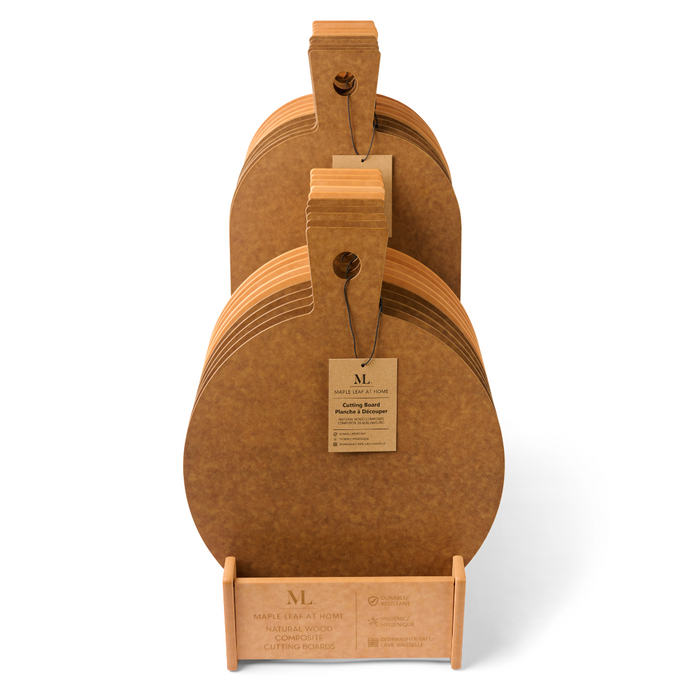 A set of round Natural Wood Composite Hostess Boards with handles, stacked upright in a stand. Each dishwasher safe board has a tag, and the wooden stand displays the Maple brand name.
