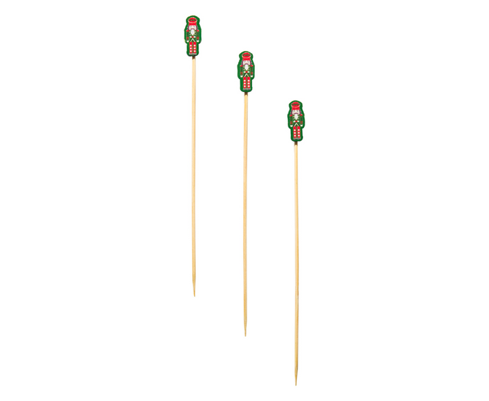 Simply Serv'd Nutcracker Christmas Large Cocktail Picks (30pk) feature festive red, green, and white figures. These compostable picks add a cheerful touch to holiday entertaining and are shown arranged upright against a white background.