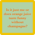 The Orange Juice Coaster by Drinks On Me features orange text on a light green square with a yellow border: "Is it just me or does orange juice taste funny without champagne?" Perfect for bar cart accessories or hostess gifts.