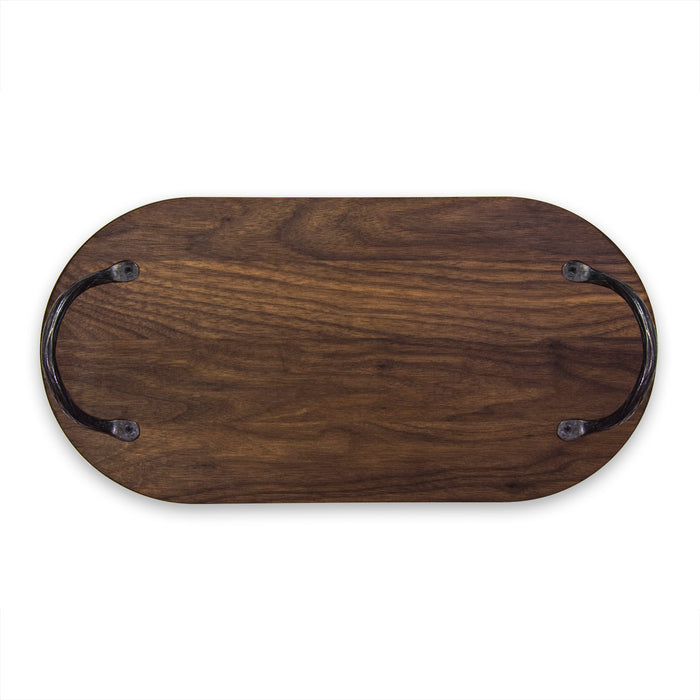 The Maple Oval Walnut Wood Artisan Board (20 x 9") features a dark finish and two black metal handles at each end, displayed against a white background.