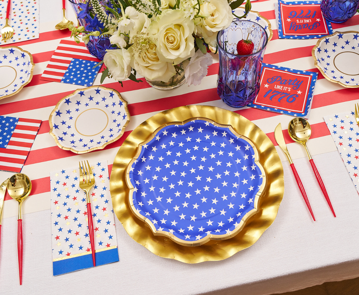 Create a festive July 4th table with Sophistiplate’s Party in the USA Dinner Plates (8pk), gold chargers, red and gold cutlery, American flag napkins, patriotic flowers, and themed cards—perfect for your Independence Day celebration.