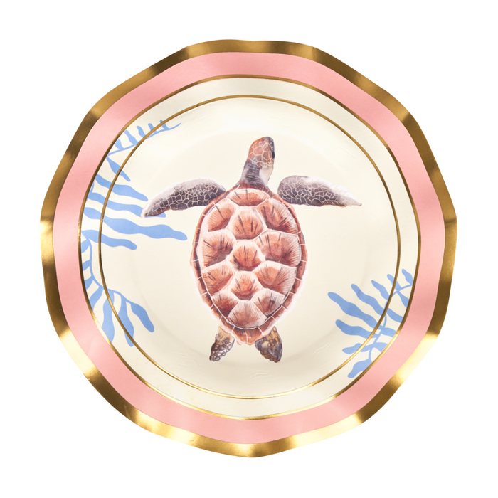 The Pastel Sea Salad Plates (8-pack) by Sophistiplate are beautifully decorated with gold and pink rims, a charming sea turtle illustration at the center, and blue coral-inspired accents along the edges—making them an excellent choice for anyone looking for unique ocean-themed or sea turtle plates to elevate their next gathering.
