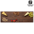 The Maple Personalized Thermal Ash Plank - Cheese & Charcuterie Board 30 x 10" features sliced cheese, crackers, green grapes, pistachios, and strawberries, with "BITES ON A BOARD" engraved in the bottom right corner.