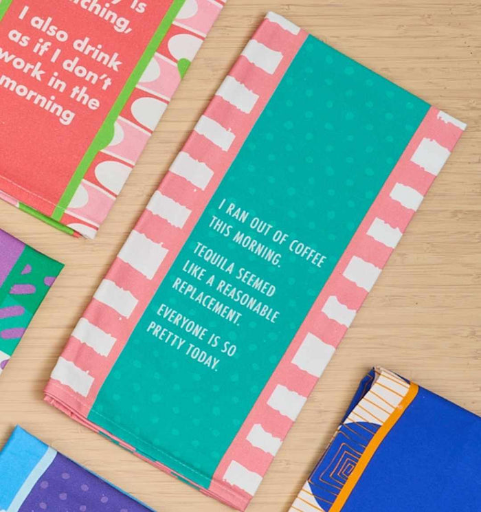 The Ran Out of Coffee Dish Towel by Drinks On Me features a funny message: “I ran out of coffee this morning. Tequila seemed like a reasonable replacement. Everyone is so pretty today.” A perfect housewarming gift! Other patterned towels also shown.