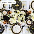 The Sophistiplate Rosh Tablescape for 16 Guests: Honeybee features an elegant bee-themed Rosh Hashanah table setting with black, gold, and white designer disposable plates, floral centerpieces, amber glasses, and gold utensils arranged neatly; a “Bundle & Save 15%” offer is displayed at the top left corner.