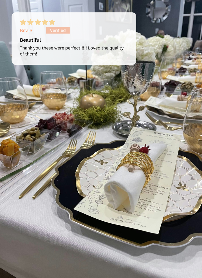 The Honeybee Table Setting by Sophistiplate LLC features gold-rimmed heavy duty plates, wine glasses, napkins with gold rings, a menu, appetizers, and floral centerpieces. A five-star review praising its beauty and quality overlays the image.