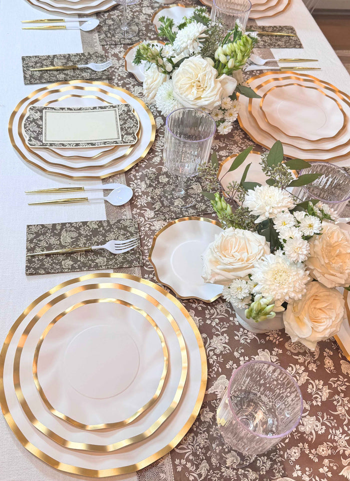 Create a stunning tablescape with the Sophistiplate Royal Peacock Table Setting in Brown & White, featuring designer disposable plates, gold cutlery, clear glasses, elegant napkins, and coordinated decor for effortless style.