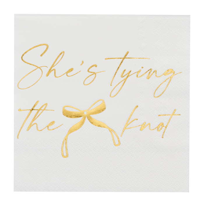 Sugarplum’s She’s tying the Knot Cocktail Napkins (26pk) feature white gold paper with elegant gold cursive text and a bow illustration—perfect for bachelorette parties or bridal showers.