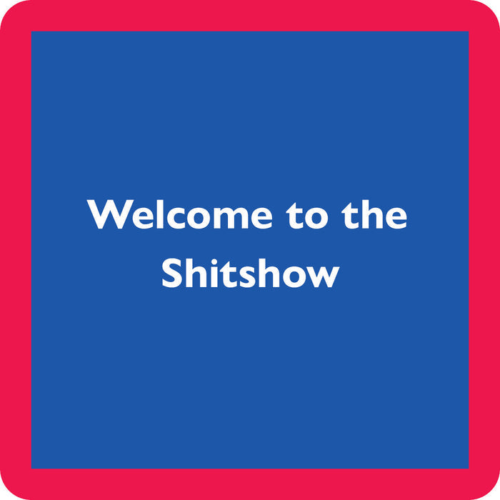 The Shit Show Coaster by Drinks On Me features bold white "Welcome to the Shitshow" text, centered on a blue square with a thick red border—an amusing drink coaster and unique gift for bar carts or housewarmings.
