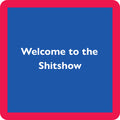 The Shit Show Coaster by Drinks On Me features bold white "Welcome to the Shitshow" text, centered on a blue square with a thick red border—an amusing drink coaster and unique gift for bar carts or housewarmings.