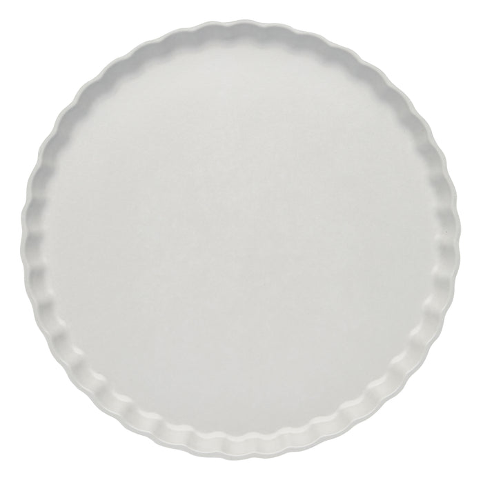 A round, white pie or tart pan with fluted edges, viewed from above against a white background—ideal for pairing with Sophistiplate’s Simply Eco Dinner Plate-Concrete/8pkg.