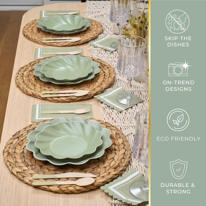 The Eco-friendly Table Setting- Sage by Sophistiplate LLC features green scalloped compostable plates, wooden cutlery, green napkins, and woven placemats—highlighting on-trend design, easy cleanup, strength, and sustainability.