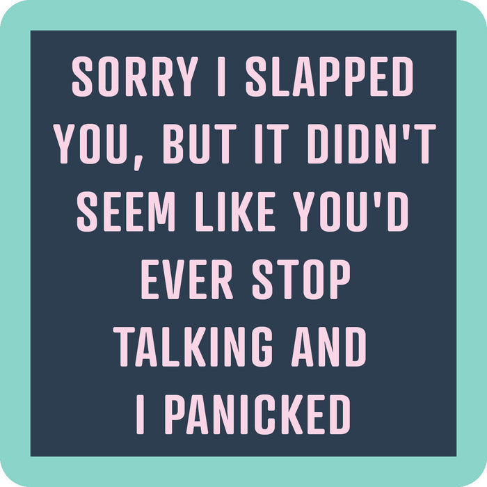 Text on a dark blue background with a teal border reads: Sorry I slapped you, but it didn’t seem like you’d ever stop talking and I panicked in light pink uppercase letters. The Slapped Coaster by Drinks On Me is a funny gift or fun addition to any bar cart.